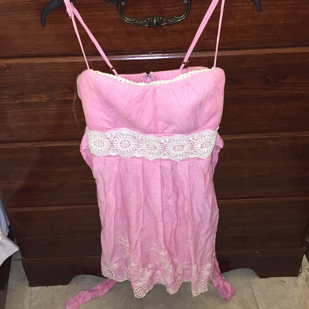Pretty pink dress with lace trimmings.